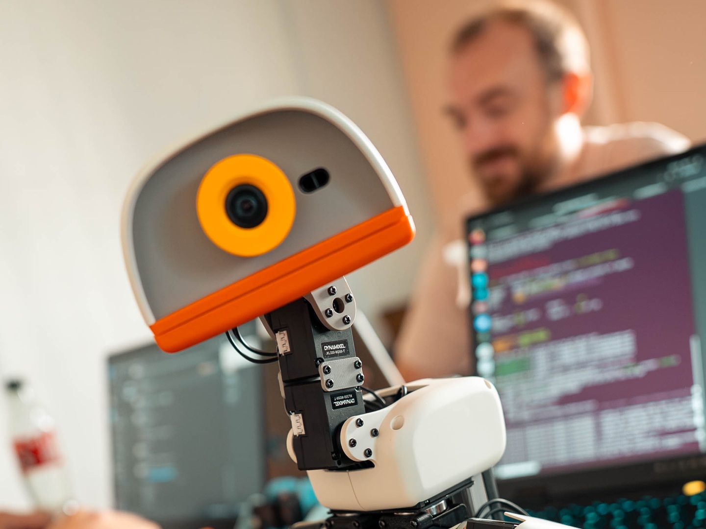 A Microduck on a desk with a person working at a computer behind it