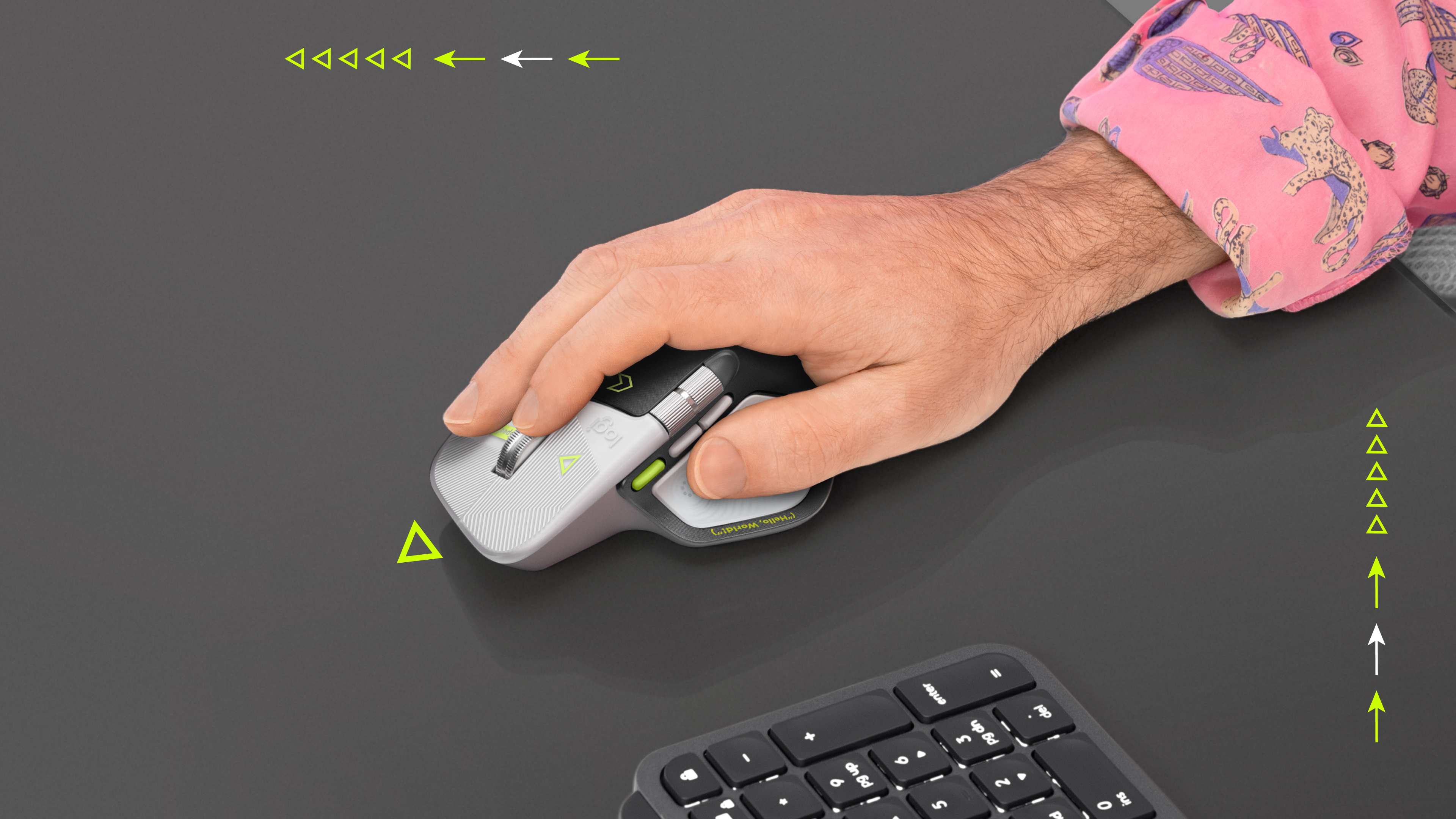 A hand using the MX Master 4 Developer Edition beside a keyboard.