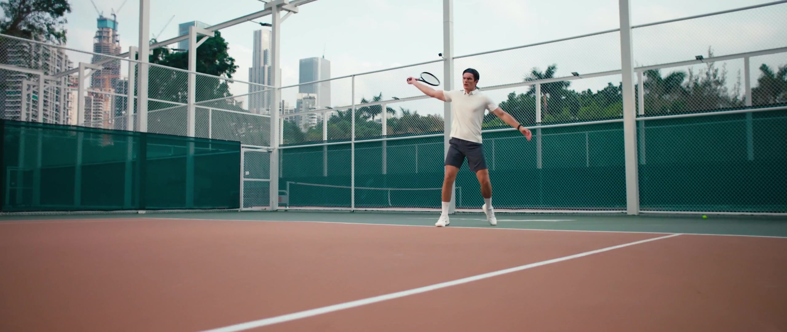Tennis player returning a shot on an outdoor court in Pongbot’s Aura demonstration.