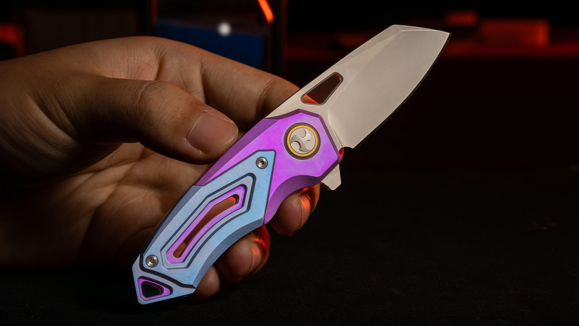 RAVEN-T anodized titanium folding knife held open in a creator-supplied photograph