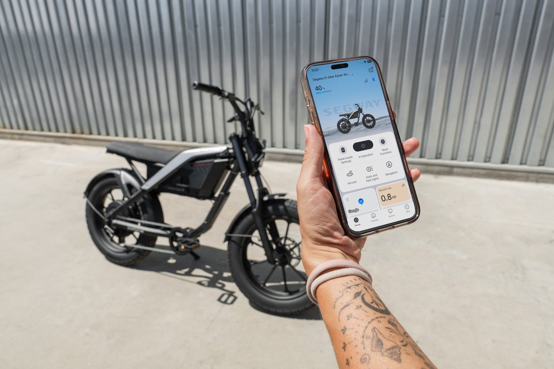 Segway Xyber Air beside a phone displaying the Segway app