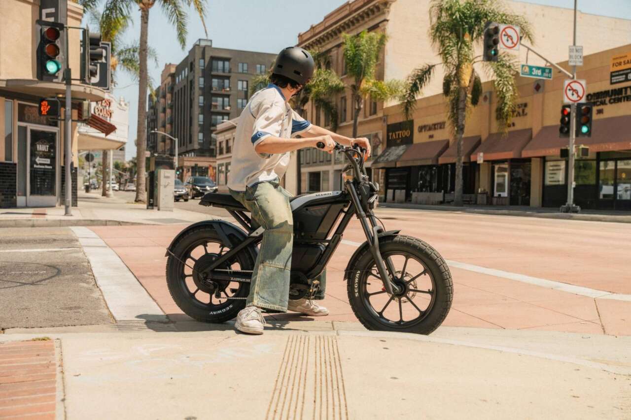 Segway Xyber Air and helmeted rider at a city intersection