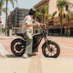 Segway Xyber Air and helmeted rider at a city intersection