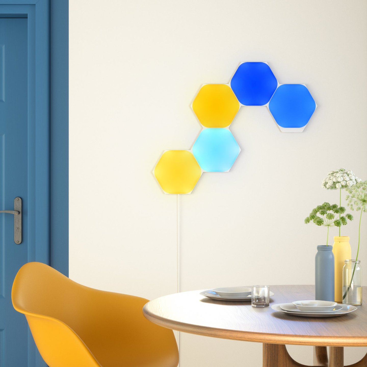 Nanoleaf Shapes panels mounted beside a dining table.