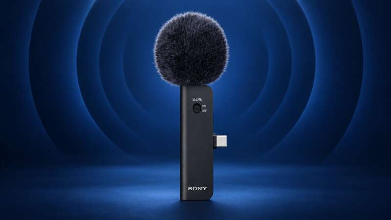 Sony ECM-AX10 microphone with its complete windscreen, USB-C connector and body on a dark blue acoustic-themed backdrop