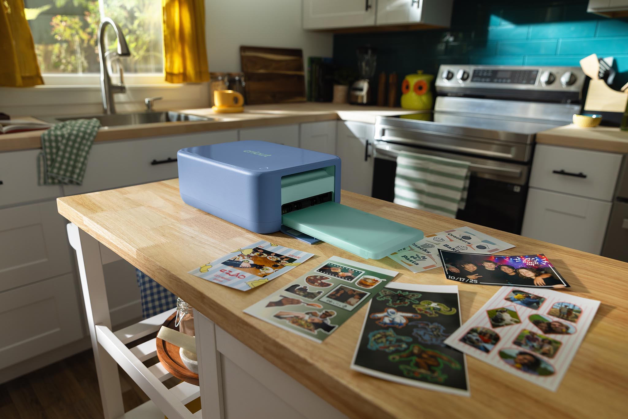 Cricut StickerPix Print + Cut beside sample custom stickers and photo prints. Image: Cricut press release.