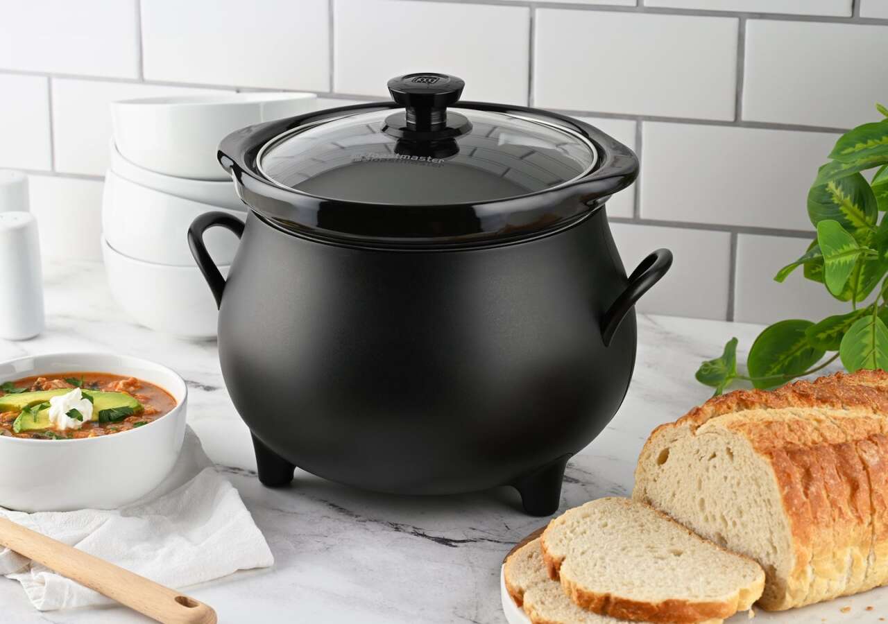 Toastmaster cauldron slow cooker with bread and soup on a kitchen counter.