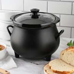 Toastmaster cauldron slow cooker with bread and soup on a kitchen counter.