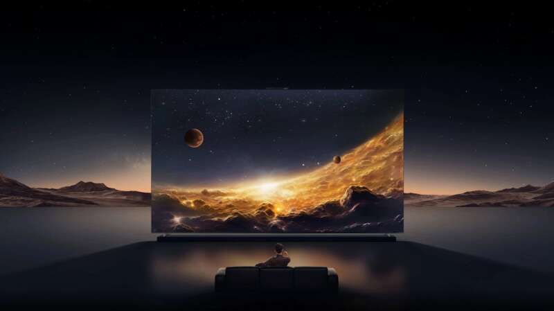 Huawei MateTV 2 Max shown in a stylized cinema scene with a seated viewer