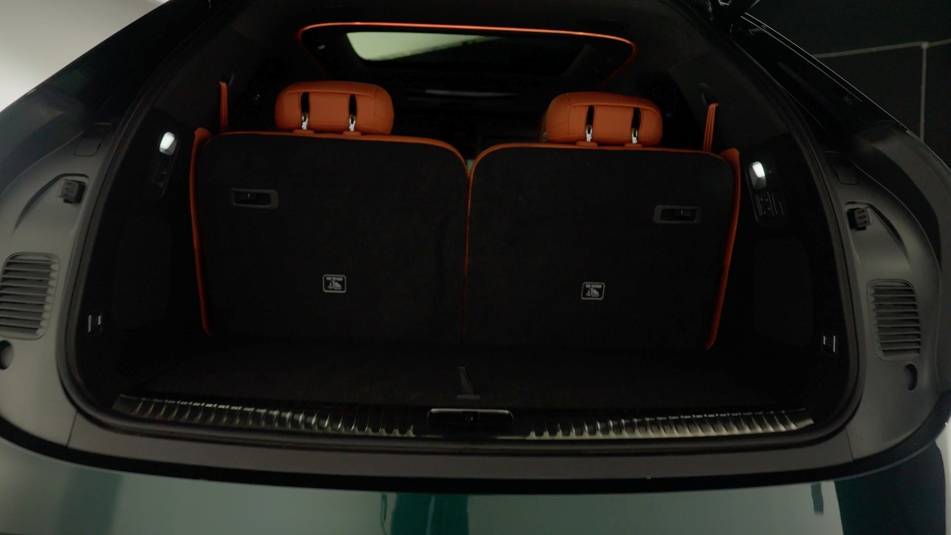 Empty luggage area beneath the open G9L tailgate with both third-row seatbacks upright.