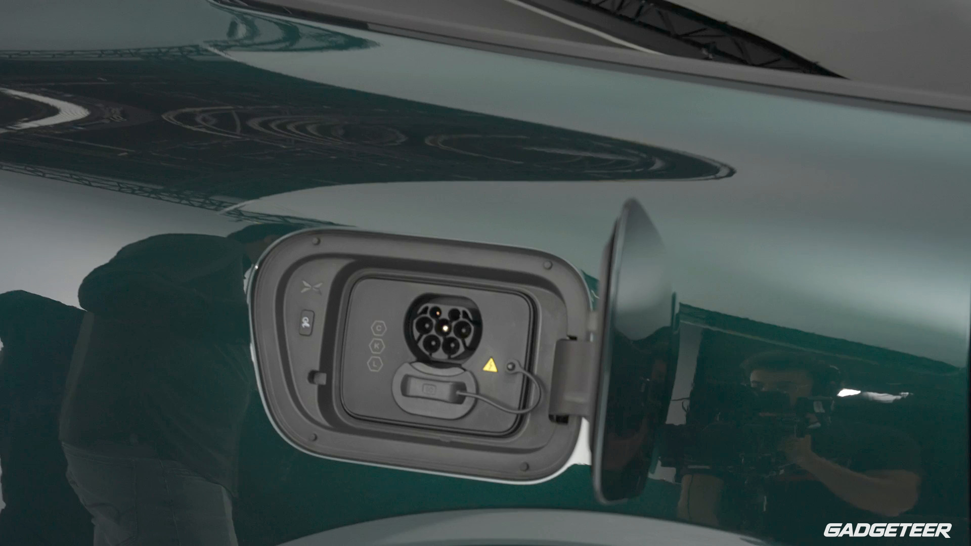 Open charging flap and charging connector on the green XPENG G9L.