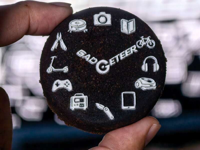 White GADGETEER logo and gadget icons printed on a used espresso puck.
