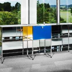 Mirrored USM Haller sideboard with the unique Zenith DEFY Chronograph USM TimeForArt watch in a glass-walled room